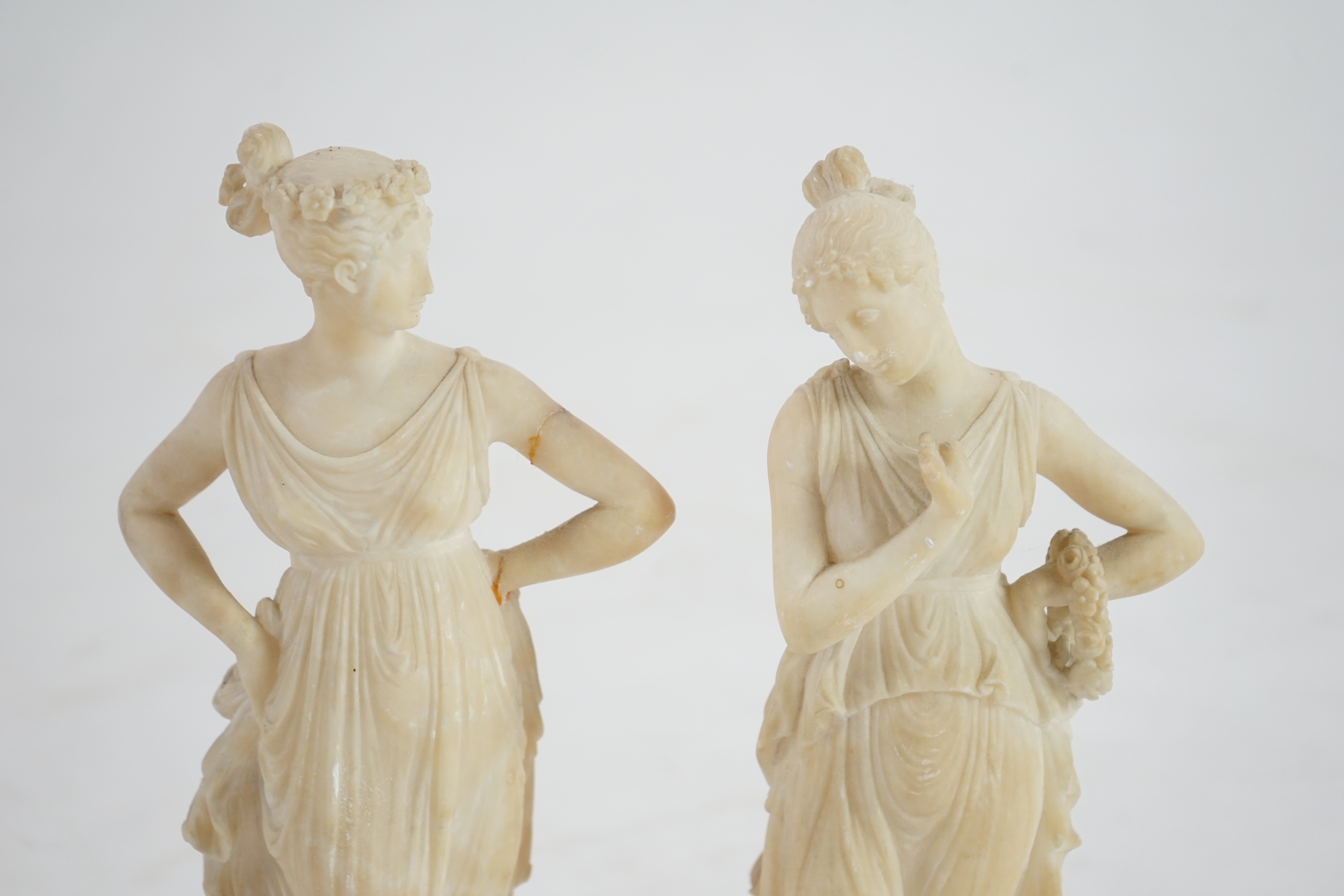 After the antique, a pair of 19th century Italian carved alabaster figures of muses